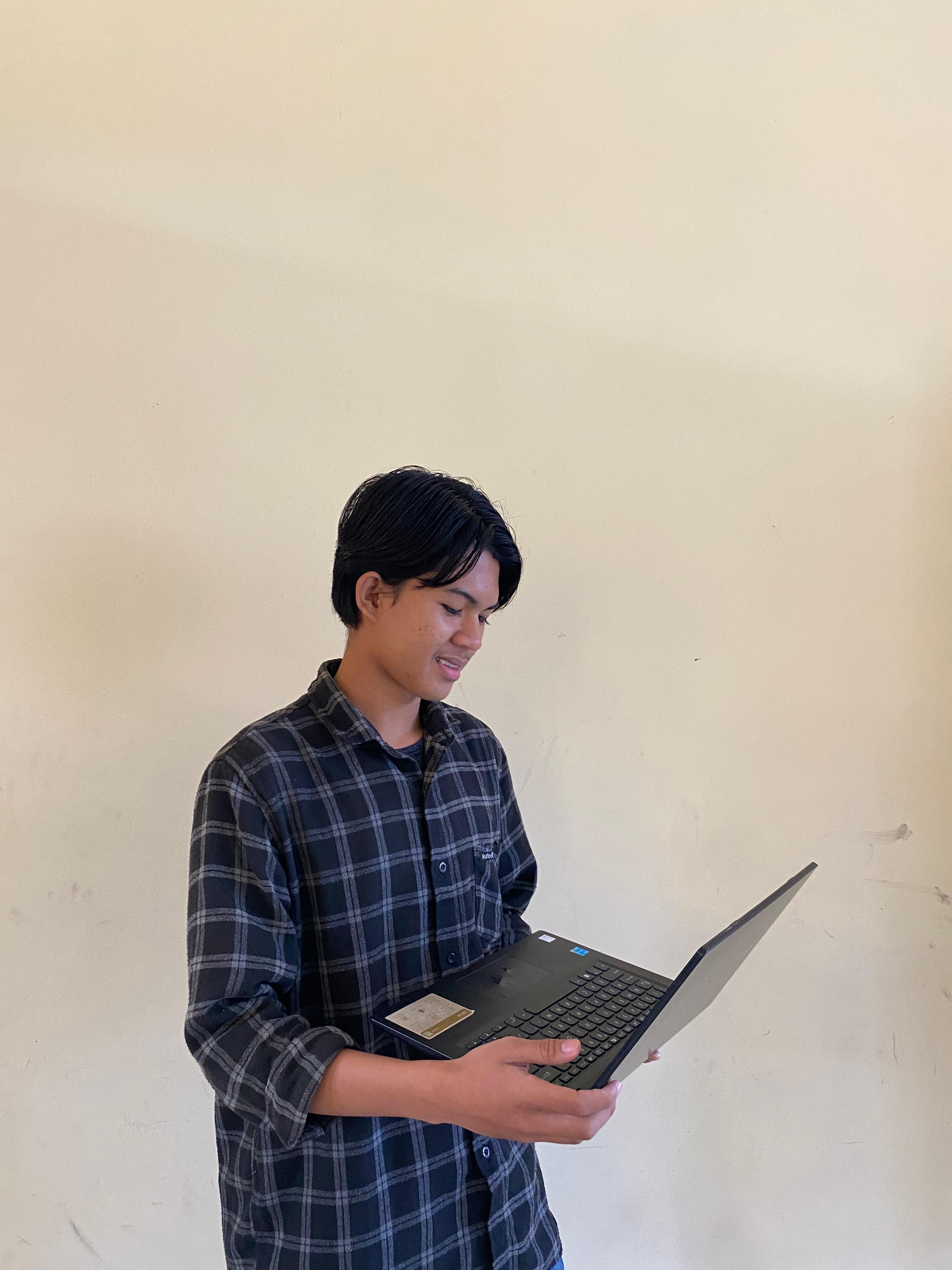 Smiling woman wearing white shirt holding multiple credit cards in her right hand, standing with left hand in pocket